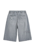 Light gray denim shorts with a distressed, paint-splattered design, shown from the back 