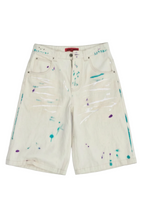 denim shorts with colorful paint splatters in teal, purple, and white,