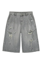 Gray distressed shorts with paint splatter details