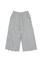 Light gray heather cropped sweatpants with a raw frayed hem, side pockets, and a decorative silver rhinestone