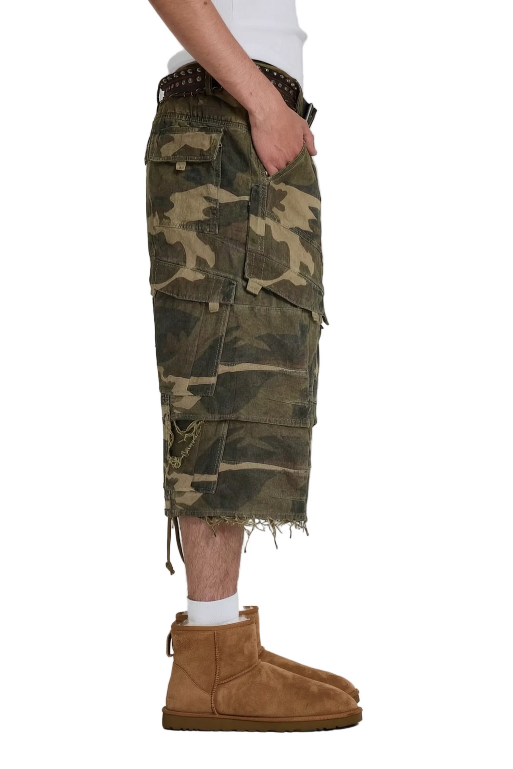 Side view of a person wearing camouflage cargo shorts with a raw, frayed hem