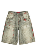 Distressed acid-wash denim shorts with red paint splatter 